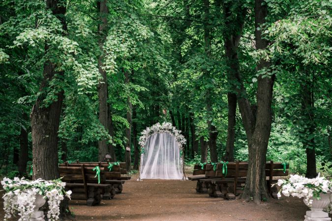 Preparing a wedding ceremony in a forest with lots of trees