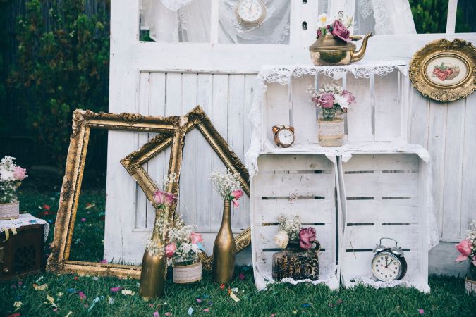 Vintage setting for a wedding with lots of clocks, dollies and other vintage objects
