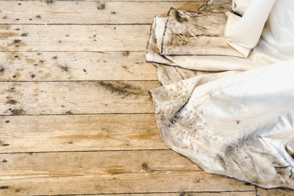 A wedding dress on a wooden floor