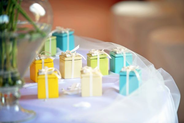 Colorful wooden keepsake boxes on a wedding table